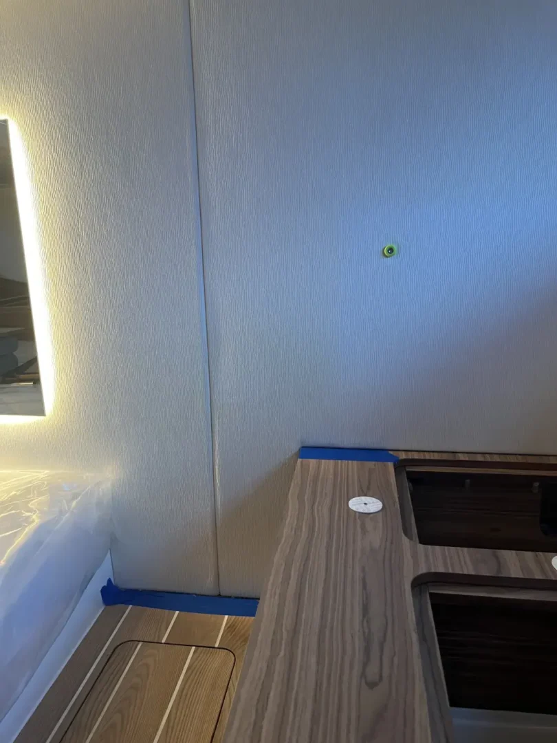 Contact Us Today Wall and desk area with visible water stain marks in a modern indoor setting.